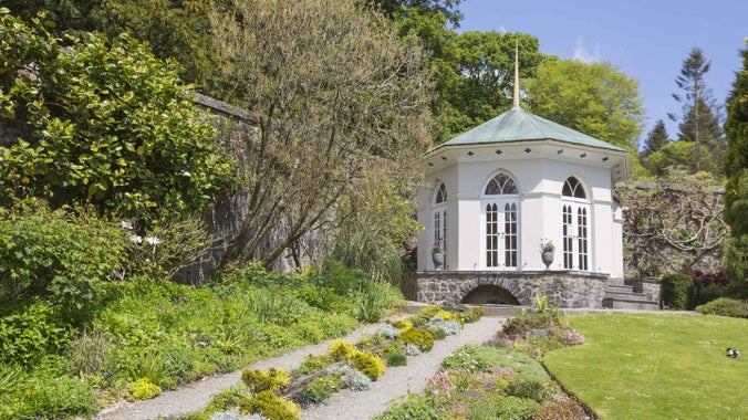 A white gazebo in the Walled Garden in summer at Colby Woodland Garden, Pembrokeshire